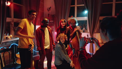 woman taking picture with music band after concert