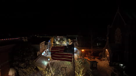 american flag flies at night