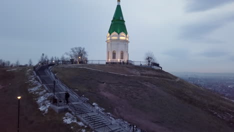 illuminated chapel on a hill at twilight