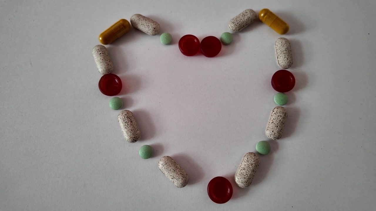 Slow Motion Assorted Pills Falling on White Background – Close-Up Healthcare Concept