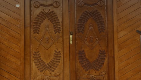 close up of wooden doors entrance to a masonic temple
