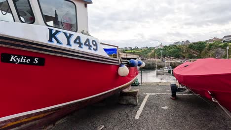 red boat docked at fife port