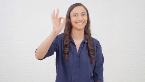 Indian-girl-appreciating-someone-with-okay-sign