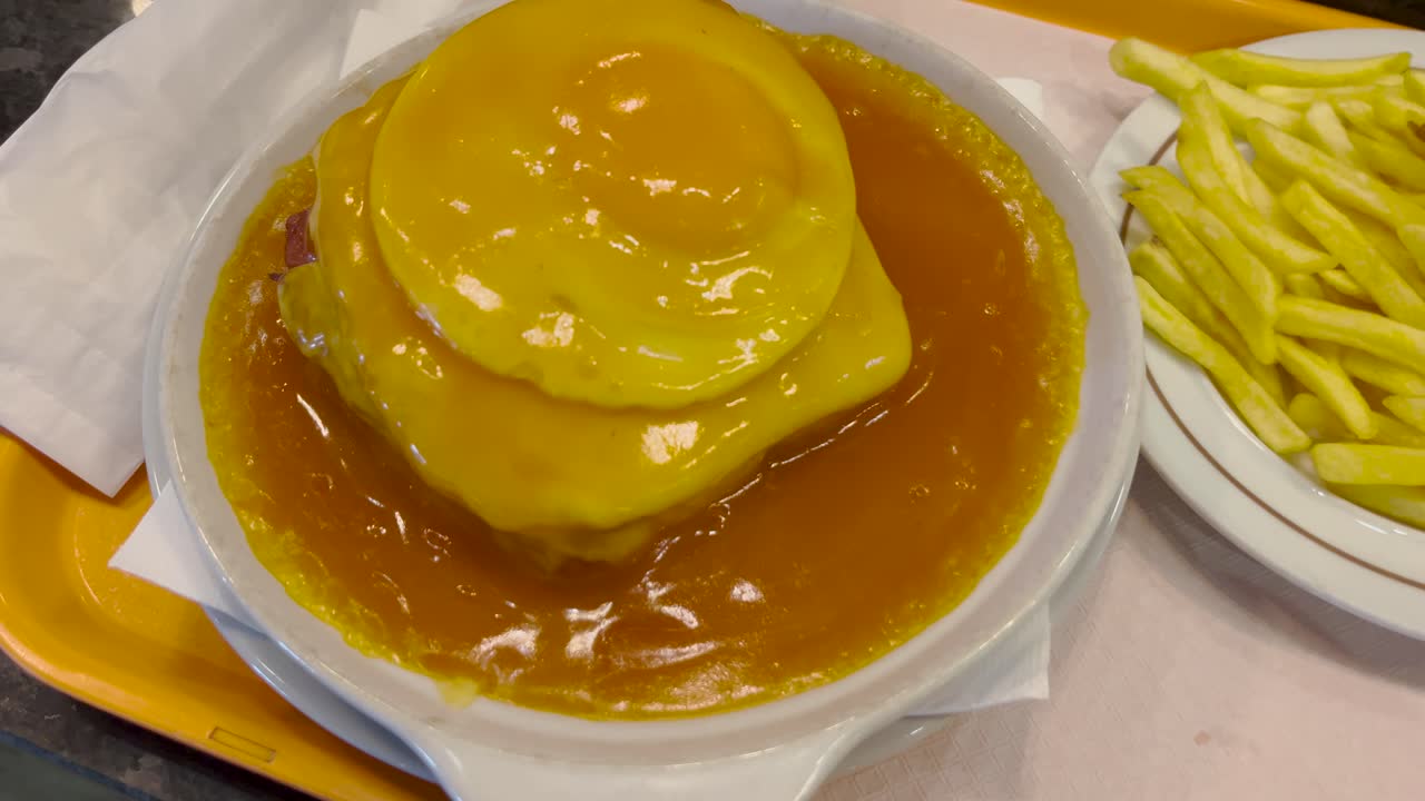 Francesinha Portuguese sandwich egg from Porto Portugal cuisine food with chips