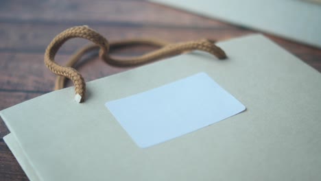 brown paper gift bag with a blank white label