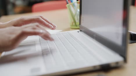 close up of hands of biracial businesswoman using laptop with copy space on screen, in slow motion