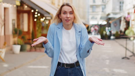 confused young woman feeling embarrassed about ambiguous question having doubts no idea outdoors