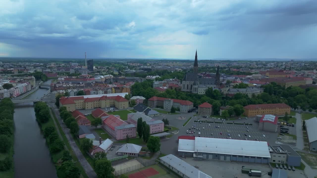 City from a drone. Olomouc with a view of the cathedral and buildings in the historic district with a river flowing through it and bridges. Evening in Moravia