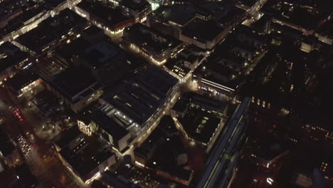 AERIAL:-Slow-Overhead-Shot-of-City-at-Night-with-Lights-and-Traffic,-Cologne,-Germany