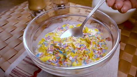 Crispy-yellow-corn-flakes-into-the-bowl-for-the-morning-a-delicious-Breakfast-with-milk.-Slow-motion-with-rotation-tracking-shot.