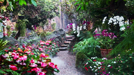 Beautiful-garden-with-flowers-and-path-leading-to-rushing-waterfall