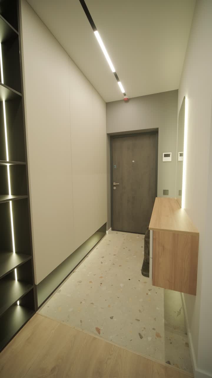 модернистский интерьер квартиры с простым декором, нейтральными тонами и чистыми линиями. дизайн подчеркивает функциональность, создавая спокойное и организованное жилое пространство.