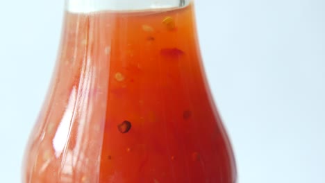 tomato sauce in a jar with fresh tomato on table