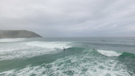 Aerial-action-cinematic-flying-over-surfers-surfing-at-Coffee-Bay-in-South-Africa