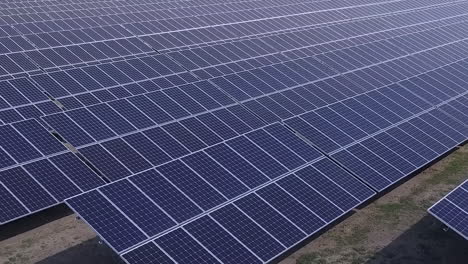 Flyover-of-huge-solar-panel-array-in-solar-power-farm,-clean-energy