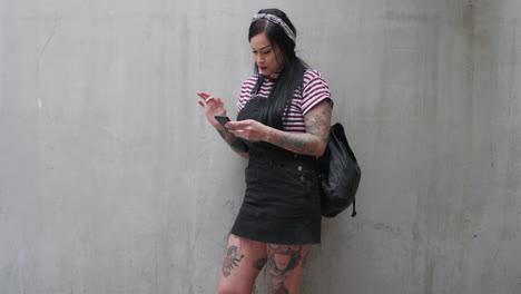 portrait-young-caucasian-woman-using-smartphone-texting-enjoying-browsing-sms-messages-on-mobile-phone-communication-app-tattoo-slow-motion