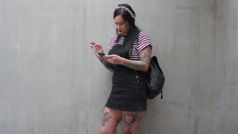 portrait young caucasian woman using smartphone texting enjoying browsing sms messages on mobile phone communication app tattoo slow motion