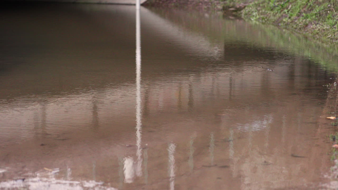 Dirty Stagnant Flood Water Under The Bridge In Leiria, Portugal After The Rain - Tilt-Up Midshot