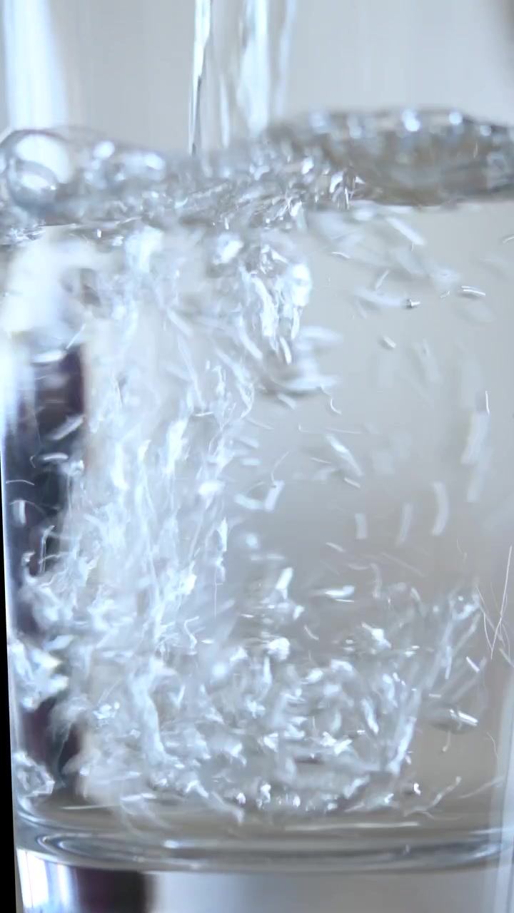 Pouring water into a glass