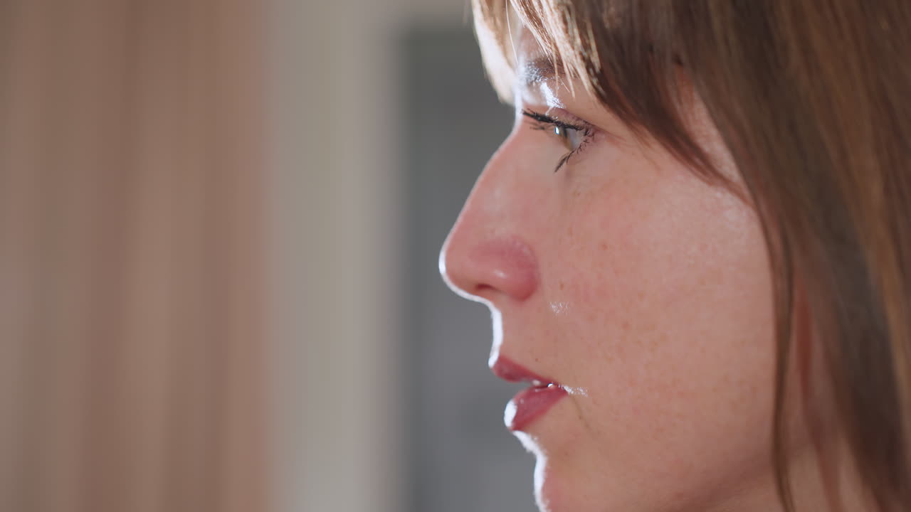 Close up of woman face speaking during counseling session, illuminated by soft studio light, revealing expressive eyes and lips, conveying empathy and attentiveness in professional wellness setting