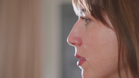 close up of woman face speaking during counseling session, illuminated by soft studio light, revealing expressive eyes and lips, conveying empathy and attentiveness in professional wellness setting