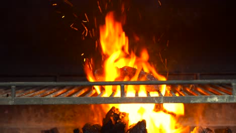 latin chef put premium angus kobe beef steak wagyu over grill charcoal bbq grid on fire sparks