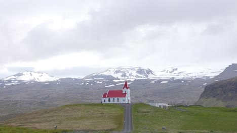 time lapse shot of clouds snow and rain above a small icelandic church or chapel in iceland