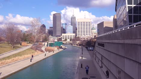 establishing shot of downtown city skyline and riverfront walk indianapolis indiana 1