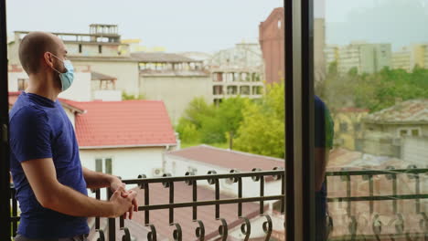 man trying to relax on the balcony of his apartment