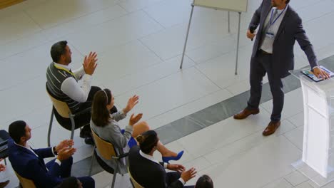 Male-speaker-with-clipboard-speaking-in-the-business-seminar-4k