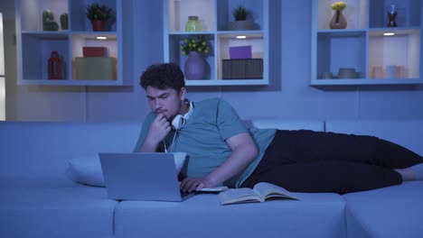 stressed and depressed male student at home at night.