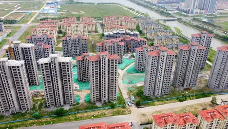 cinematic aerial view of tall chinese buildings under construction - china, nanhai new district