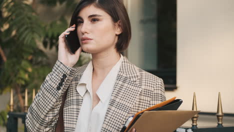 stylish woman making a business call outdoor.