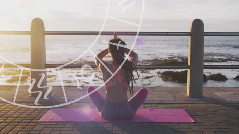 horoscope circle against rear view of african american fit woman performing yoga on the promenade