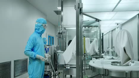 medical scientist team loading tissue culture flask sample to centrifuge machine to analyzing. advanced research lab with modern equipment. drug vaccine development in professional biotechnology lab
