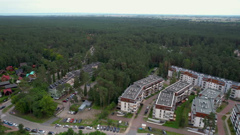 Aerial-flyover-polish-Stegna-Town-with-Neighborhood-surrounded-by-dense-forest-landscape-in-Poland