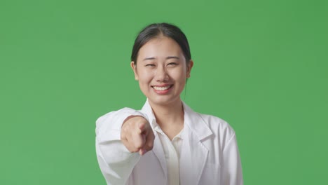 woman in lab coat pointing