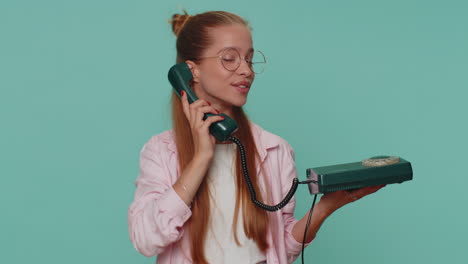 Pretty-teenager-girl-child-kid-talking-on-wired-vintage-telephone-of-80s-says-hey-you-call-me-back