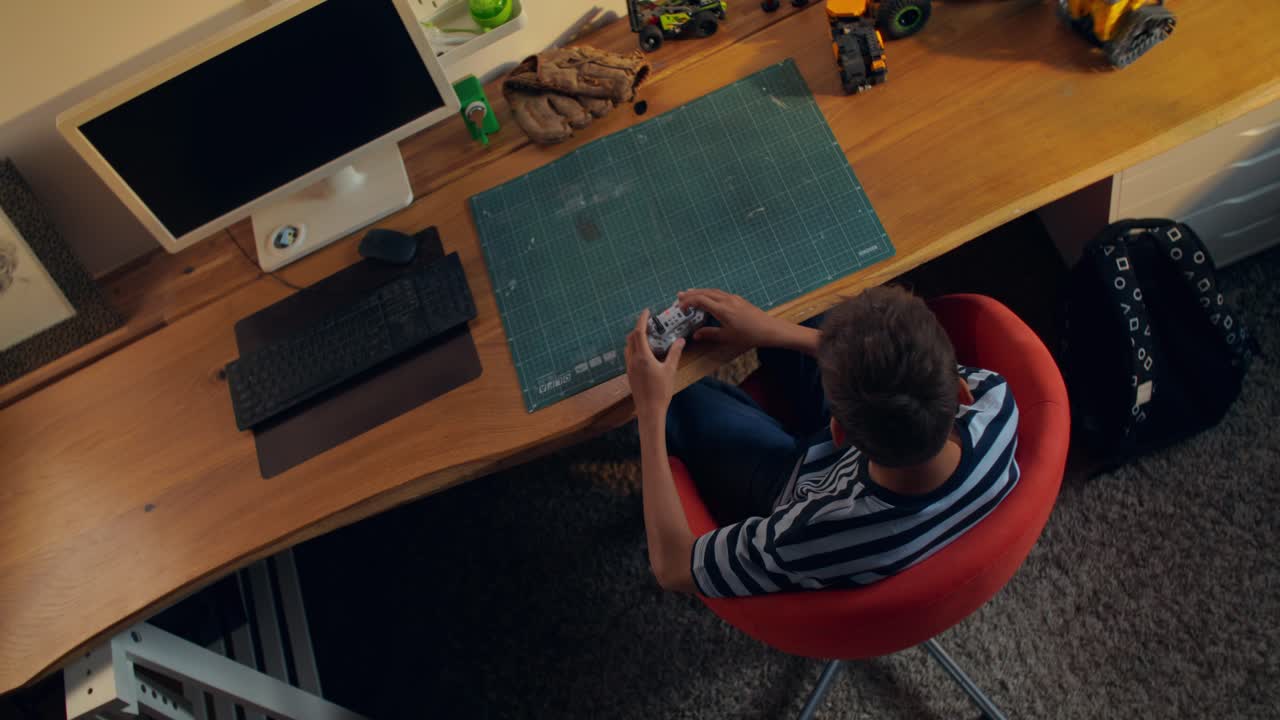 Boy Playing Video Games at His Desk