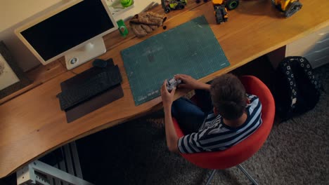 boy playing video games at his desk
