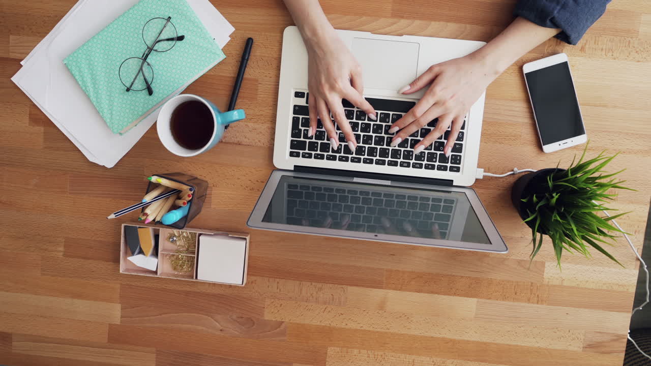 Woman working on laptop at a modern office desk