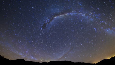 star trails and milky way over mountains