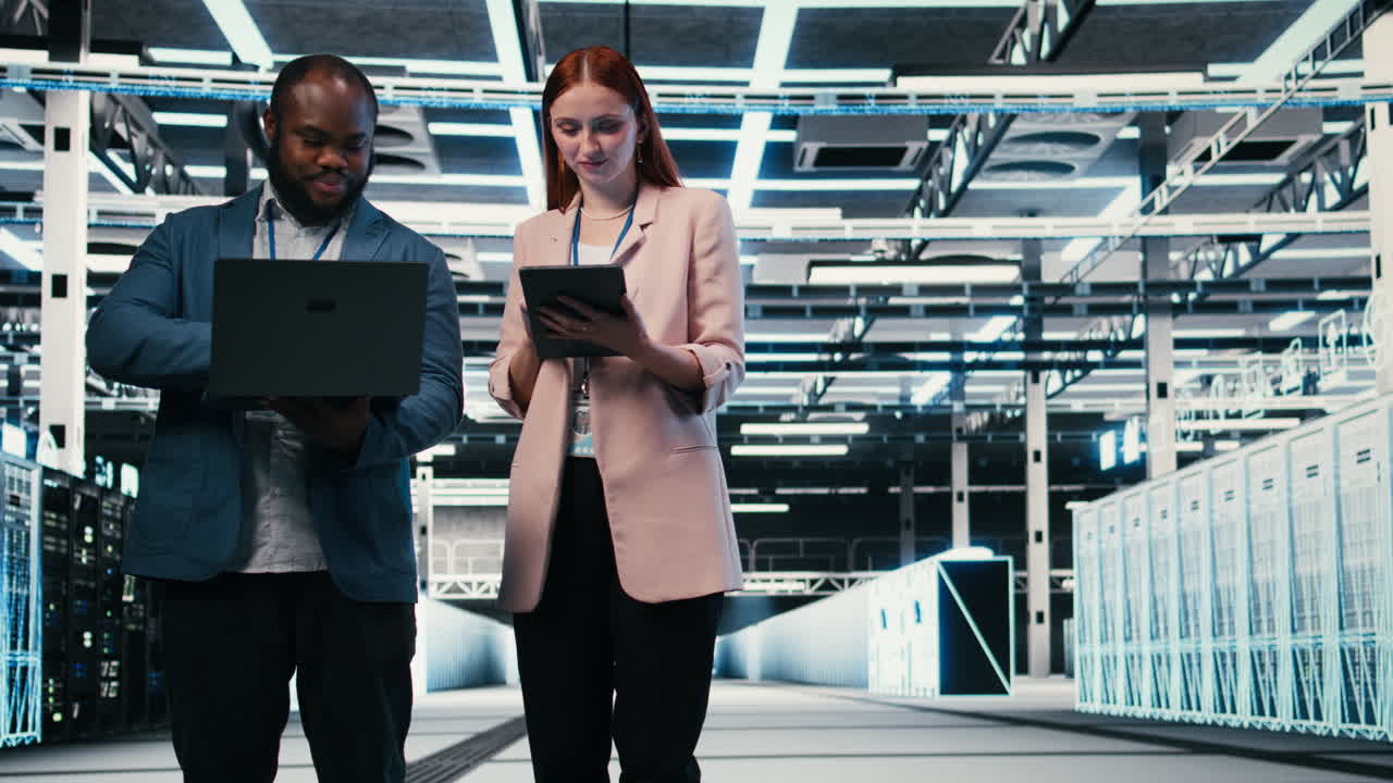 Professionisti IT che collaborano con laptop e tablet in un data center.