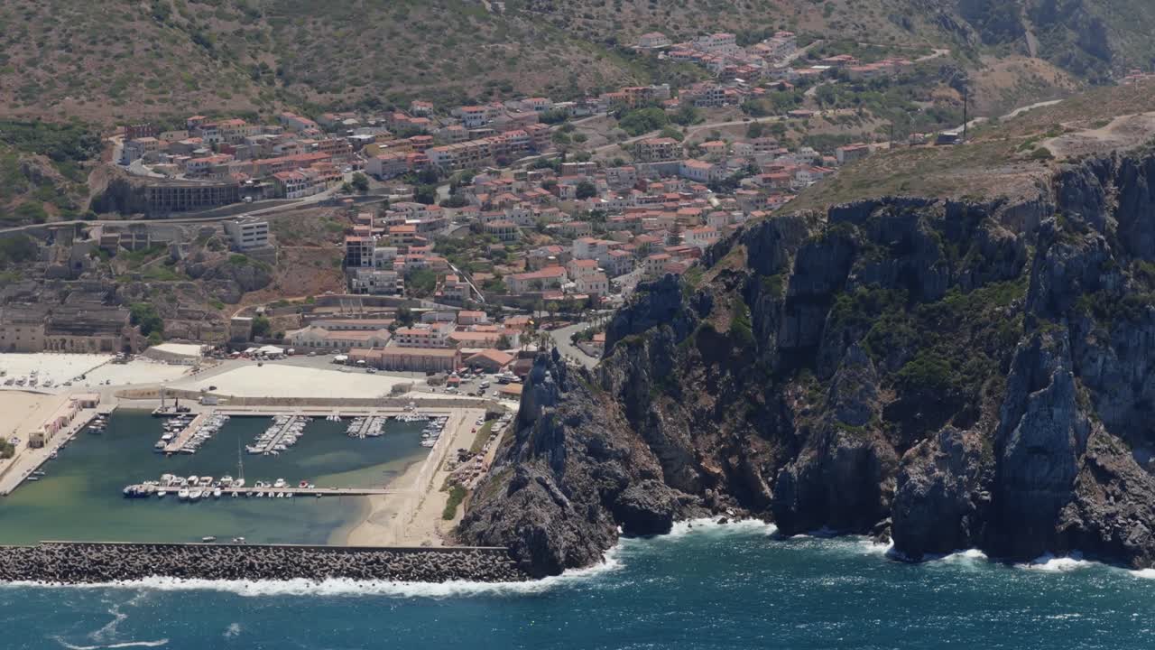 Coastal town Buggerru with marina, rocky cliffs, sunny, Sardegna beauty