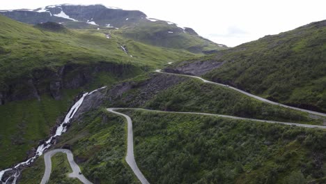 halsabakkane winding roads at vikafjellet mountain crossing close to myrkdalen in western norway - beautiful aerial sideview of lush mountain meadow with road in hillside