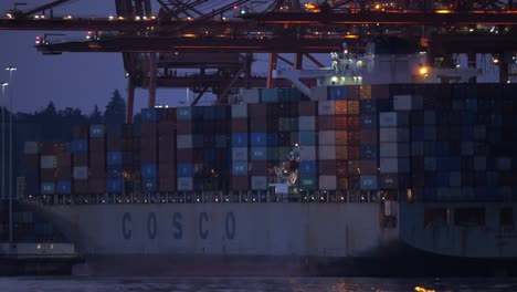 docked full freight cosco container ship static