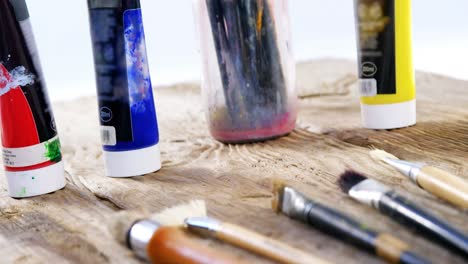 Various-paint-brushes-on-wooden-table