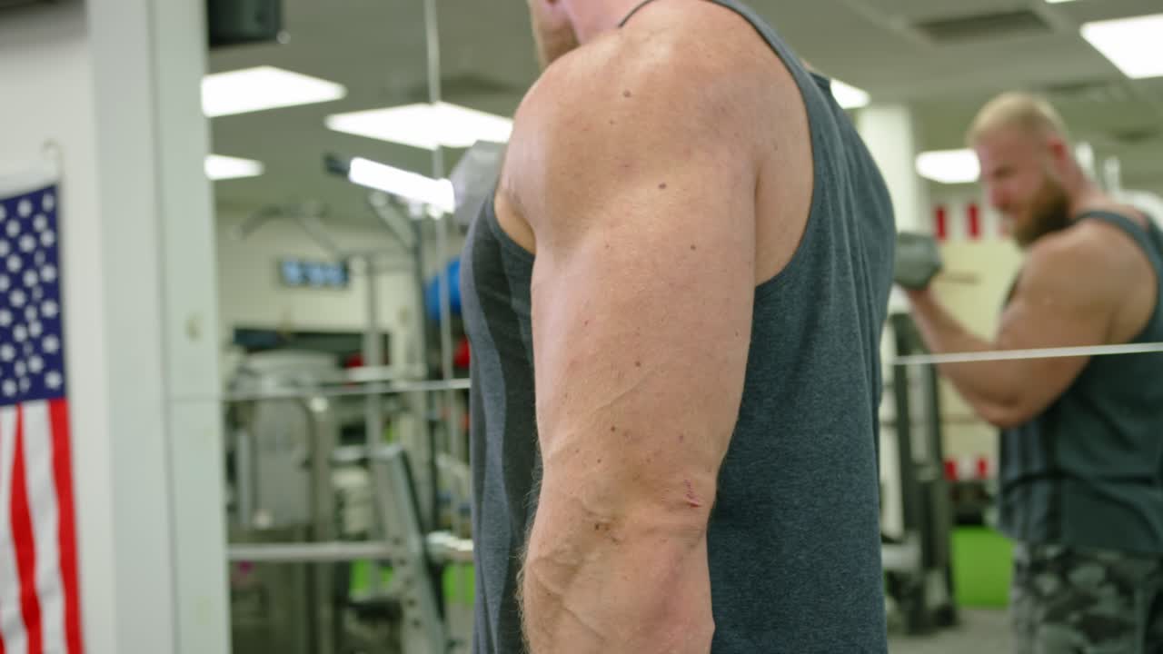 Strong bodybuilder strength workout in sport club