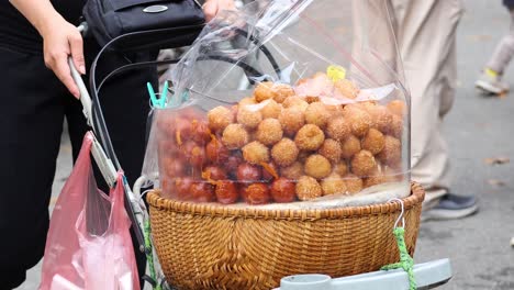 vendor pushing cart with snacks in hanoi