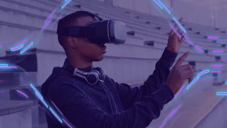 animation of glowing light trails of data transfer over african american man in vr headset